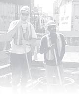 A graphic of two men standing near a manhole.